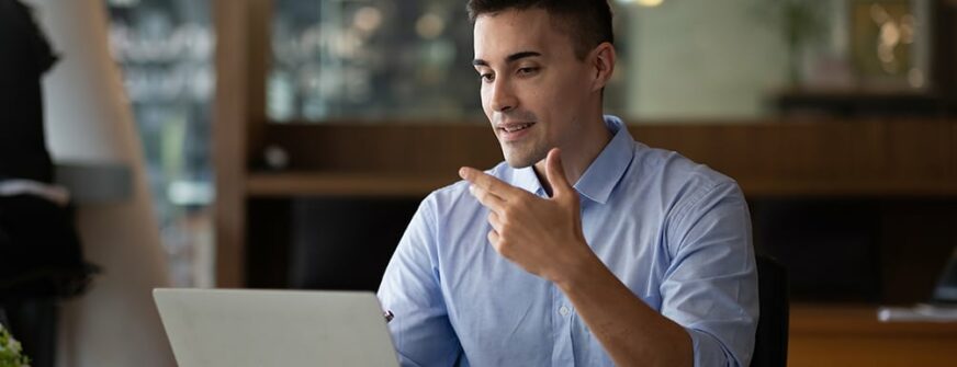 smiling businessman having virtual team meeting call, talking, remotely working at home watching online learning training webinar in remote office.